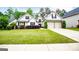 Charming home featuring a two-car garage, complemented by lush green landscaping and manicured bushes at 1015 Buckeye Ln, Villa Rica, GA 30180