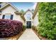 Welcoming front entrance with a glass-paneled door, surrounded by beautifully landscaped greenery at 1015 Buckeye Ln, Villa Rica, GA 30180