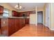 Large kitchen featuring hardwood floors, cherry cabinets, and a breakfast bar peninsula at 1015 Buckeye Ln, Villa Rica, GA 30180