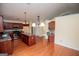 Spacious kitchen featuring hardwood floors, cherry cabinets, granite countertops, and stainless appliances at 1015 Buckeye Ln, Villa Rica, GA 30180