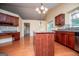 Open-concept kitchen featuring an island and cherry wood cabinets at 1015 Buckeye Ln, Villa Rica, GA 30180