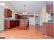 Spacious kitchen featuring hardwood floors, cherry cabinets, granite countertops, and a center island at 1015 Buckeye Ln, Villa Rica, GA 30180