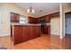 Bright kitchen featuring hardwood floors, cherry cabinets, granite countertops, and stainless steel appliances at 1015 Buckeye Ln, Villa Rica, GA 30180