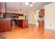 Open kitchen with hardwood floors, cherry cabinets, stainless appliances, and a kitchen island at 1015 Buckeye Ln, Villa Rica, GA 30180