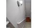 Carpeted staircase leading to hardwood flooring with a wall-mounted light fixture at 1015 Buckeye Ln, Villa Rica, GA 30180