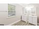 Bright bathroom with and sinks features a window for natural light at 1427 Timms Se Cir, Atlanta, GA 30316