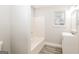 Bathroom with tub/shower combo, new floors, and sink at 1427 Timms Se Cir, Atlanta, GA 30316