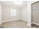 This bedroom with wood-look flooring features a closet and window at 1427 Timms Se Cir, Atlanta, GA 30316