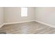 Neutral bedroom with wood-look flooring and a bright window at 1427 Timms Se Cir, Atlanta, GA 30316