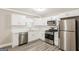 Modern kitchen featuring stainless steel appliances, white cabinets and a window at 1427 Timms Se Cir, Atlanta, GA 30316