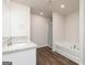 Bathroom featuring granite countertop, sink, tub, and standing shower at 240 Oliver Dr, Locust Grove, GA 30248