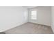 Bedroom with neutral carpet and a window at 240 Oliver Dr, Locust Grove, GA 30248