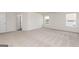 Spacious bedroom with carpet, two windows, and a door at 240 Oliver Dr, Locust Grove, GA 30248