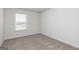 Bright carpeted bedroom with a window at 240 Oliver Dr, Locust Grove, GA 30248