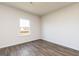 Empty bedroom with wood-look flooring, a window, and neutral-colored walls at 240 Oliver Dr, Locust Grove, GA 30248