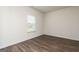 Bright and airy bedroom with wood-look flooring and a large window at 240 Oliver Dr, Locust Grove, GA 30248