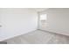 Bright and empty bedroom with carpeted floors and bright window at 240 Oliver Dr, Locust Grove, GA 30248