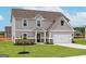 Charming two-story house with a two-car garage, green lawn, and a welcoming front entrance at 240 Oliver Dr, Locust Grove, GA 30248