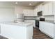 Well-lit kitchen with granite countertops, stainless steel appliances, and white cabinetry at 240 Oliver Dr, Locust Grove, GA 30248