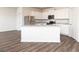 Modern kitchen with white cabinets, granite countertops, stainless steel appliances, and island sink at 240 Oliver Dr, Locust Grove, GA 30248