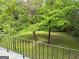 View of backyard from deck featuring lush green grass and mature trees at 132 N Johnson St, Bowdon, GA 30108