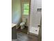 Updated bathroom with walk-in shower and new toilet, bright natural light at 132 N Johnson St, Bowdon, GA 30108