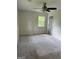 Carpeted bedroom with natural light and ceiling fan at 132 N Johnson St, Bowdon, GA 30108