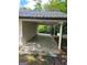 Carport featuring concrete flooring, white siding, and wooded views at 132 N Johnson St, Bowdon, GA 30108