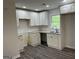 Modern kitchen with granite countertops, white cabinets, and stainless steel sink at 132 N Johnson St, Bowdon, GA 30108
