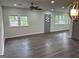 Open living room featuring laminate floors, neutral walls and ample natural light at 132 N Johnson St, Bowdon, GA 30108