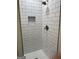 Updated shower featuring white subway tile surround and built-in shower niche at 132 N Johnson St, Bowdon, GA 30108