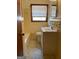 Tidy bathroom featuring a single vanity, window, and yellow tiling at 8672 Bowden St, Douglasville, GA 30134