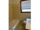 Clean bathroom featuring a tub and toilet under a window at 8672 Bowden St, Douglasville, GA 30134