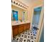 Bathroom featuring dual vanity, a bathtub, and eye-catching geometric tile flooring at 4832 Batiste Ln, Acworth, GA 30101