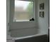 Clean white bathtub under a window allowing for natural light at 4832 Batiste Ln, Acworth, GA 30101