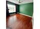 Empty bedroom with hardwood floors, ceiling fan and a large window at 4832 Batiste Ln, Acworth, GA 30101