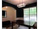 Dining room boasting dark blue accent wall and view of green outdoors at 4832 Batiste Ln, Acworth, GA 30101