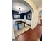 Dining room with wainscoting, modern chandelier, and dark blue accent wall, adjacent to entry at 4832 Batiste Ln, Acworth, GA 30101
