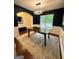 Dining room featuring large area rug, wood table and view to the main entrance at 4832 Batiste Ln, Acworth, GA 30101