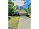 Charming two-story home featuring a stone facade and a well-manicured front lawn at 4832 Batiste Ln, Acworth, GA 30101