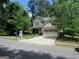 Charming two-story home featuring a stone and siding facade, manicured lawn, and attached two-car garage at 4832 Batiste Ln, Acworth, GA 30101