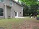 Back exterior view featuring a patio, backyard, and lush greenery at 4832 Batiste Ln, Acworth, GA 30101