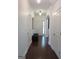 Bright hallway featuring hardwood floors, white walls, and traditional fixtures at 4832 Batiste Ln, Acworth, GA 30101