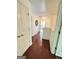 Bright hallway with hardwood floors, white walls, and access to other rooms at 4832 Batiste Ln, Acworth, GA 30101