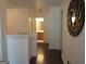 Bright hallway with hardwood floors and decorative mirror leading to the bathroom at 4832 Batiste Ln, Acworth, GA 30101