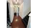 Spacious hallway with dark wood floors, and white doors leading to the bedrooms at 4832 Batiste Ln, Acworth, GA 30101