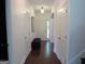 Bright hallway featuring hardwood floors, white walls, and traditional fixtures at 4832 Batiste Ln, Acworth, GA 30101