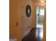 Upstairs hallway featuring hardwood floors, decorative mirror, and natural light at 4832 Batiste Ln, Acworth, GA 30101