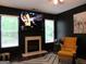 Sophisticated living room with fireplace, large windows and yellow accent chair at 4832 Batiste Ln, Acworth, GA 30101