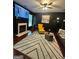 Open-concept living room featuring a fireplace and modern decor, leading to sitting area at 4832 Batiste Ln, Acworth, GA 30101